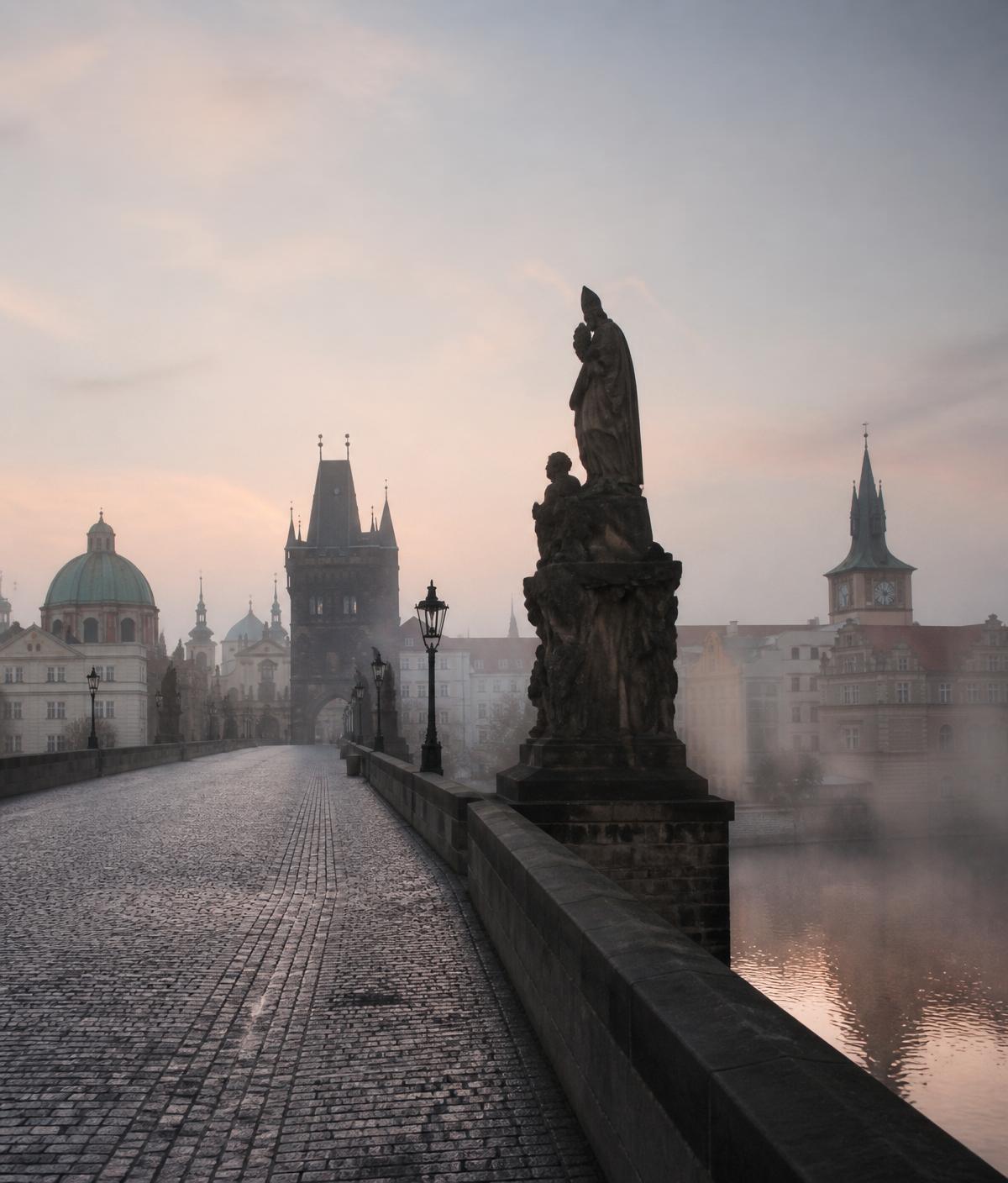 Charles Bridge in Prague at misty dawn